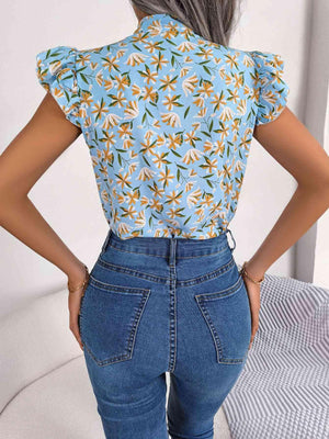 the back of a woman's top with a floral print