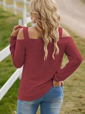 a woman wearing a red sweater and jeans