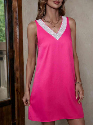 a woman in a pink dress posing for a picture