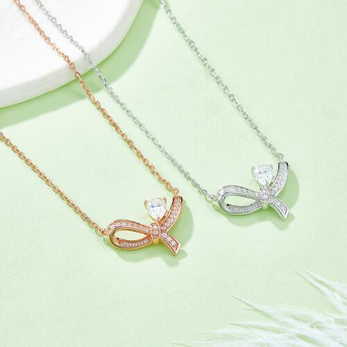 two necklaces with a bow and a diamond