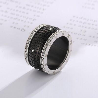 a black and white ring sitting on top of a piece of paper