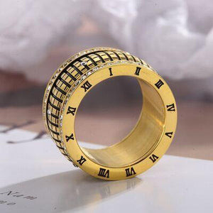 a gold ring with roman numerals on it