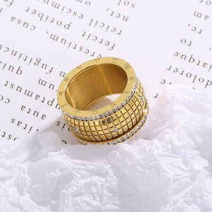 a gold ring sitting on top of a piece of paper