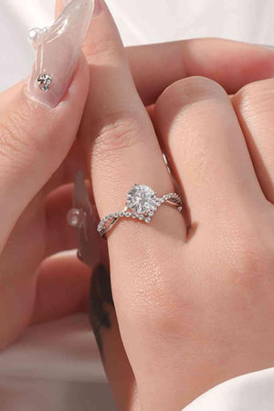 a woman's hand holding a diamond ring