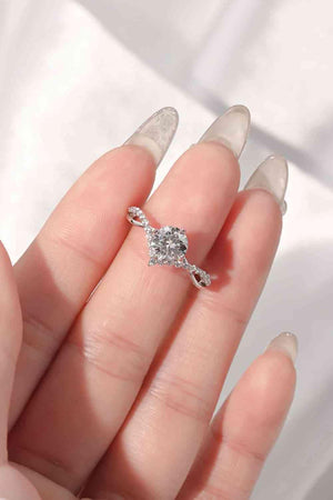 a woman's hand holding a diamond ring