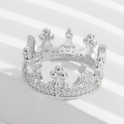 a silver crown ring on a white background