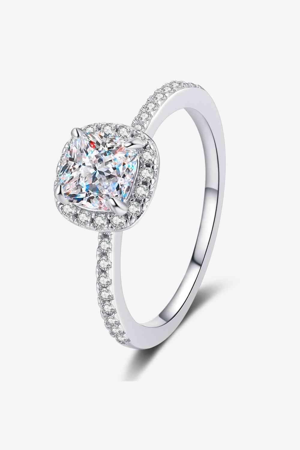 a heart shaped diamond ring with diamonds on the sides