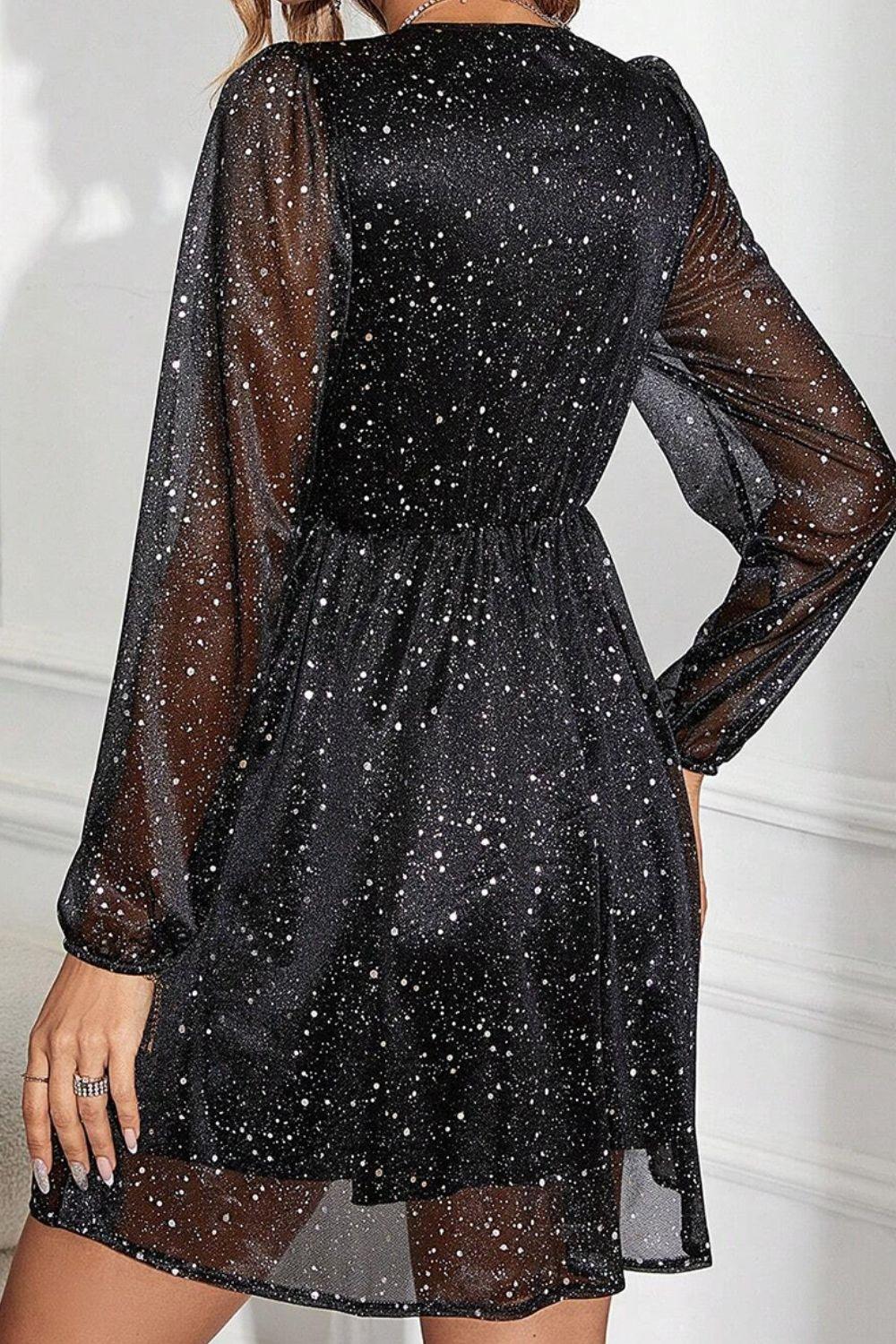 a woman wearing a black dress with stars on it