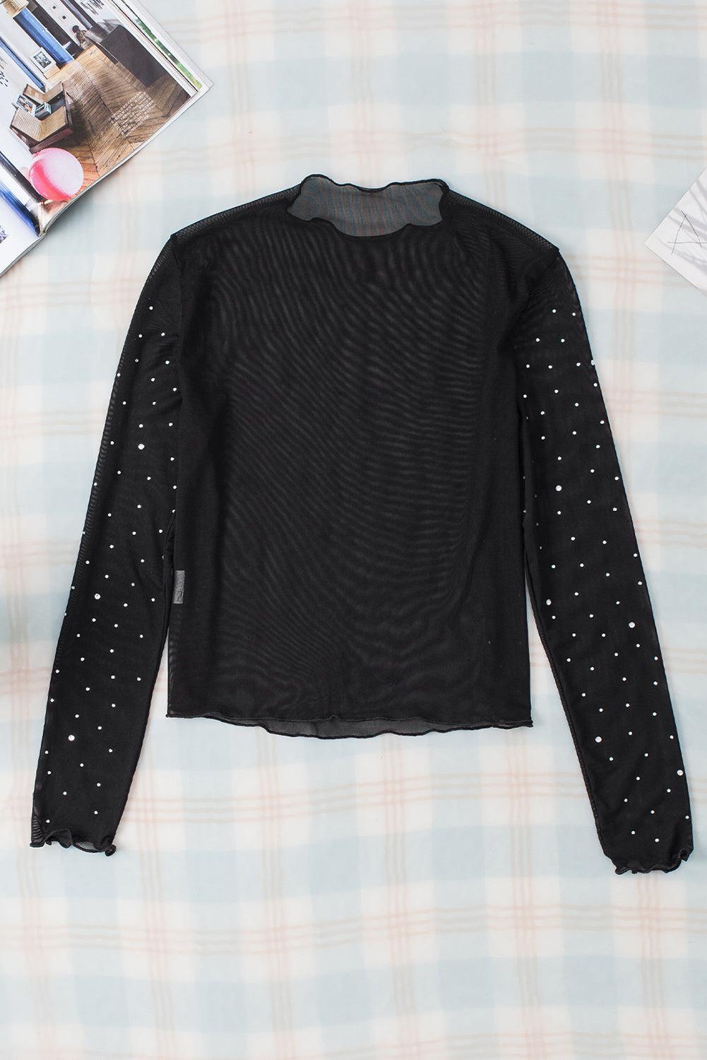 a black sweater with silver polka dots on it
