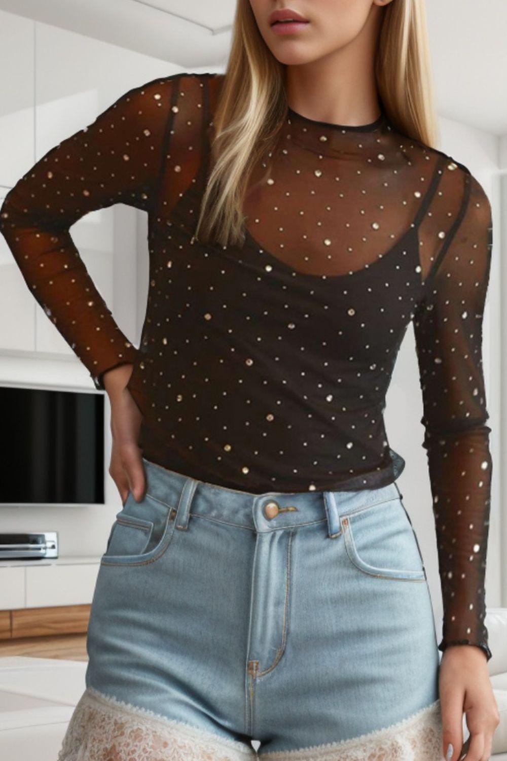 a woman wearing a sheer top and shorts