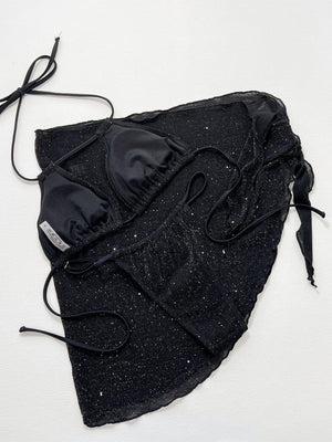 a black piece of cloth with laces on it