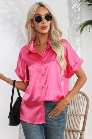 a woman wearing a pink shirt and jeans