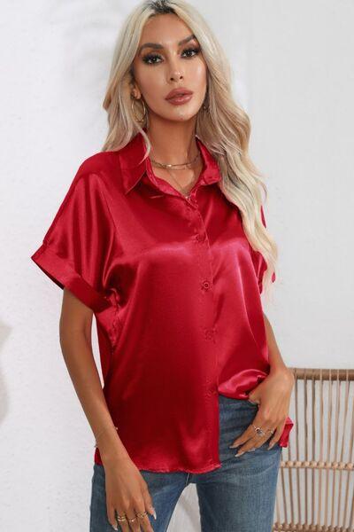 a woman wearing a red shirt and jeans