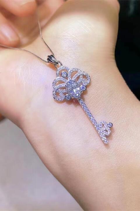 a close up of a person's arm with a diamond key on it
