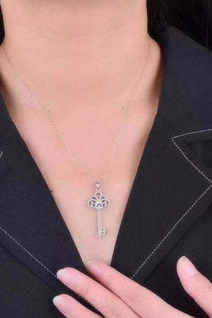 a woman wearing a necklace with a cross on it