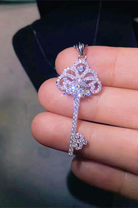 a person holding a diamond key in their hand