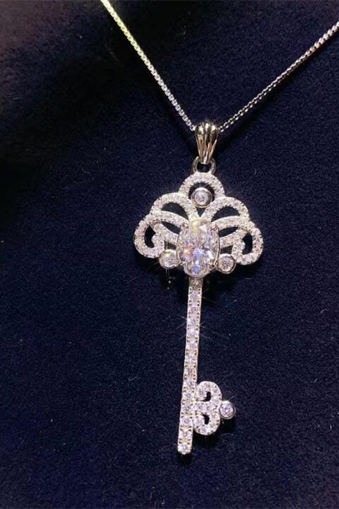 a diamond key pendant on a black background