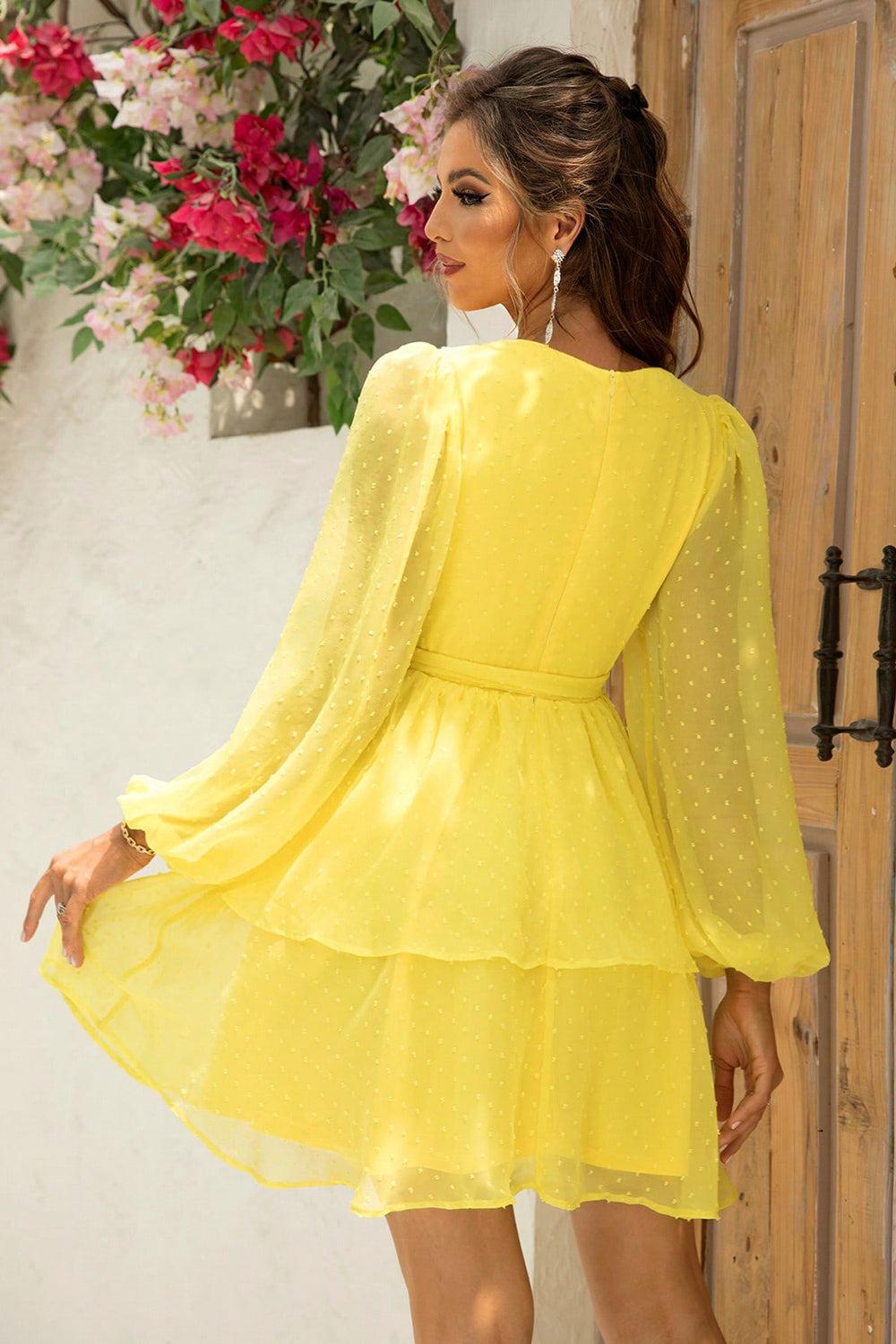 a woman in a yellow dress standing in front of a door