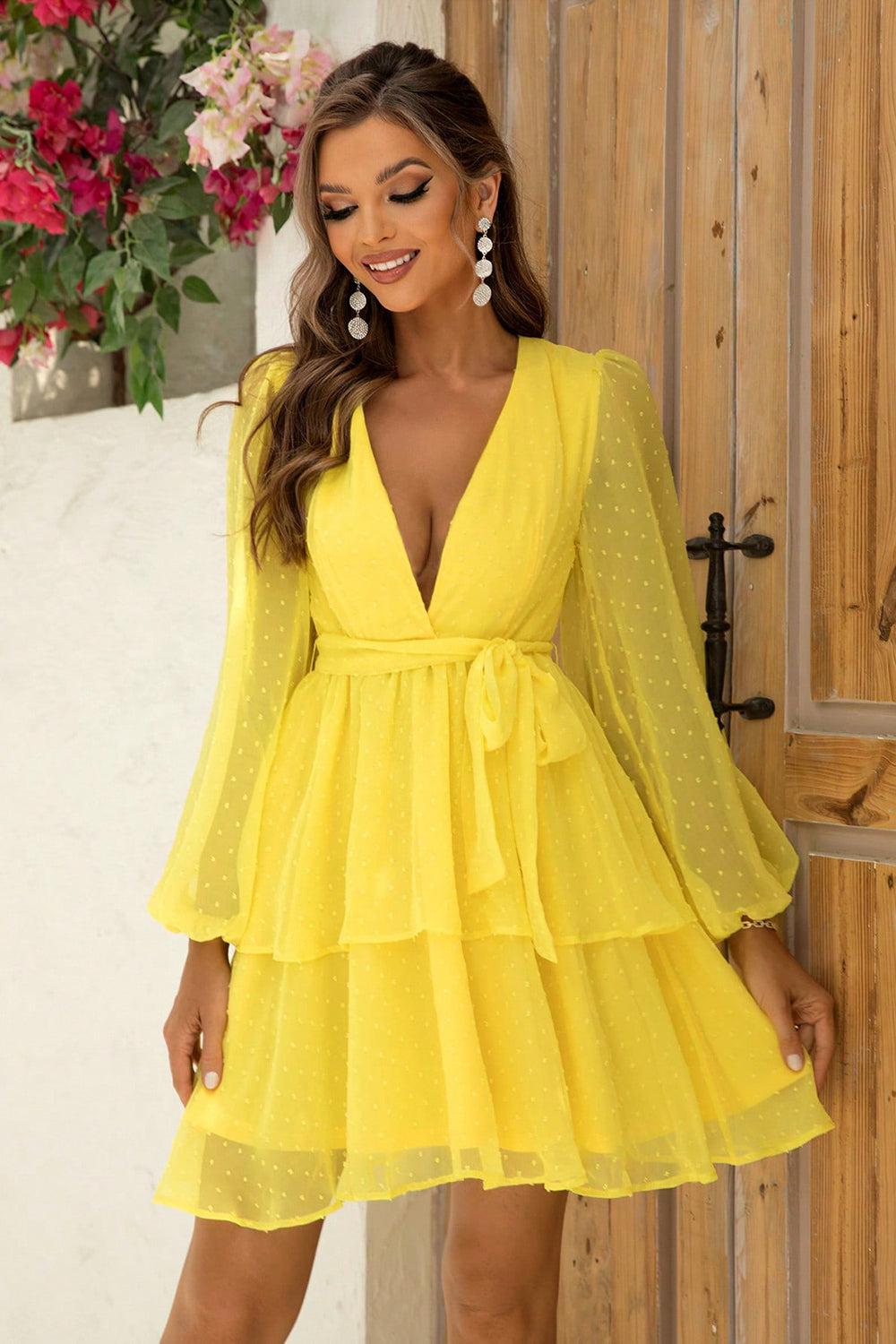 a woman in a yellow dress posing for a picture