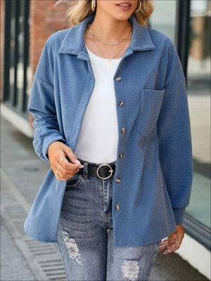 a woman wearing a blue jacket and jeans
