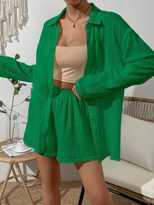 a woman wearing a green cardigan and shorts