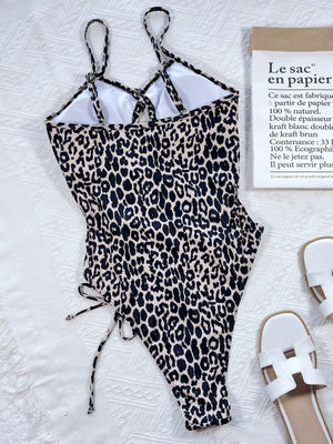 a bathing suit and sandals on a bed