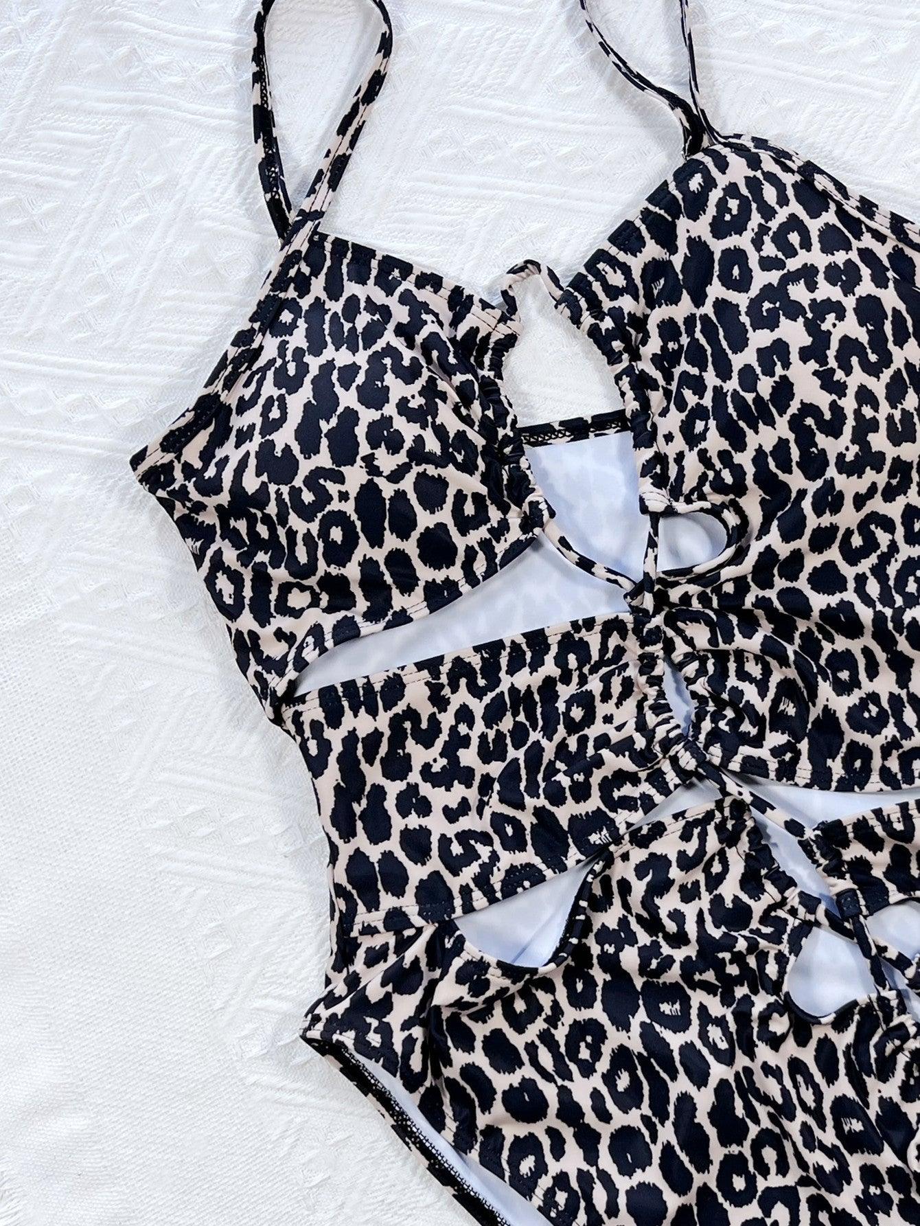 a bathing suit on a bed with white sheets
