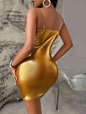 a woman in a gold dress posing for the camera