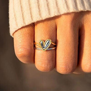 a close up of a person's hand with a ring on it