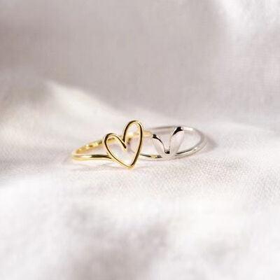 a gold ring with two hearts on it