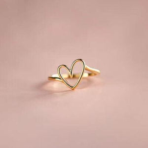 a gold ring with two hearts on it