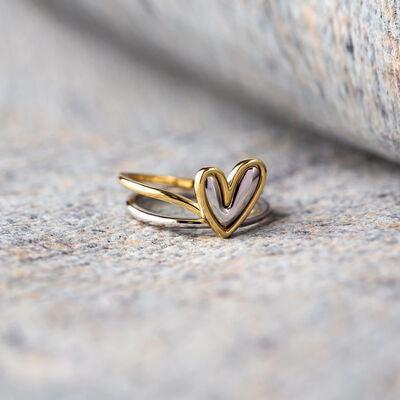 a close up of a heart shaped ring on a surface