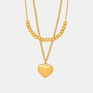 a gold necklace with a heart on it