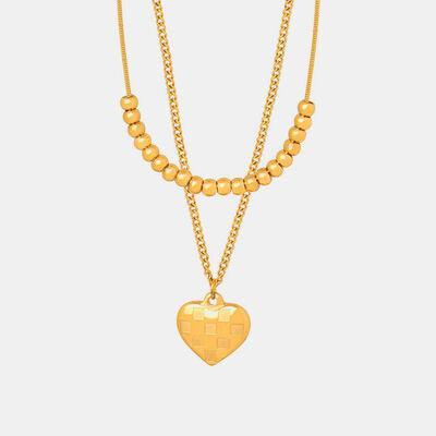 a gold necklace with a heart on it