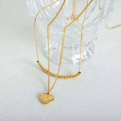 a gold necklace with a heart on it