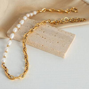 a gold chain with a white pearl necklace