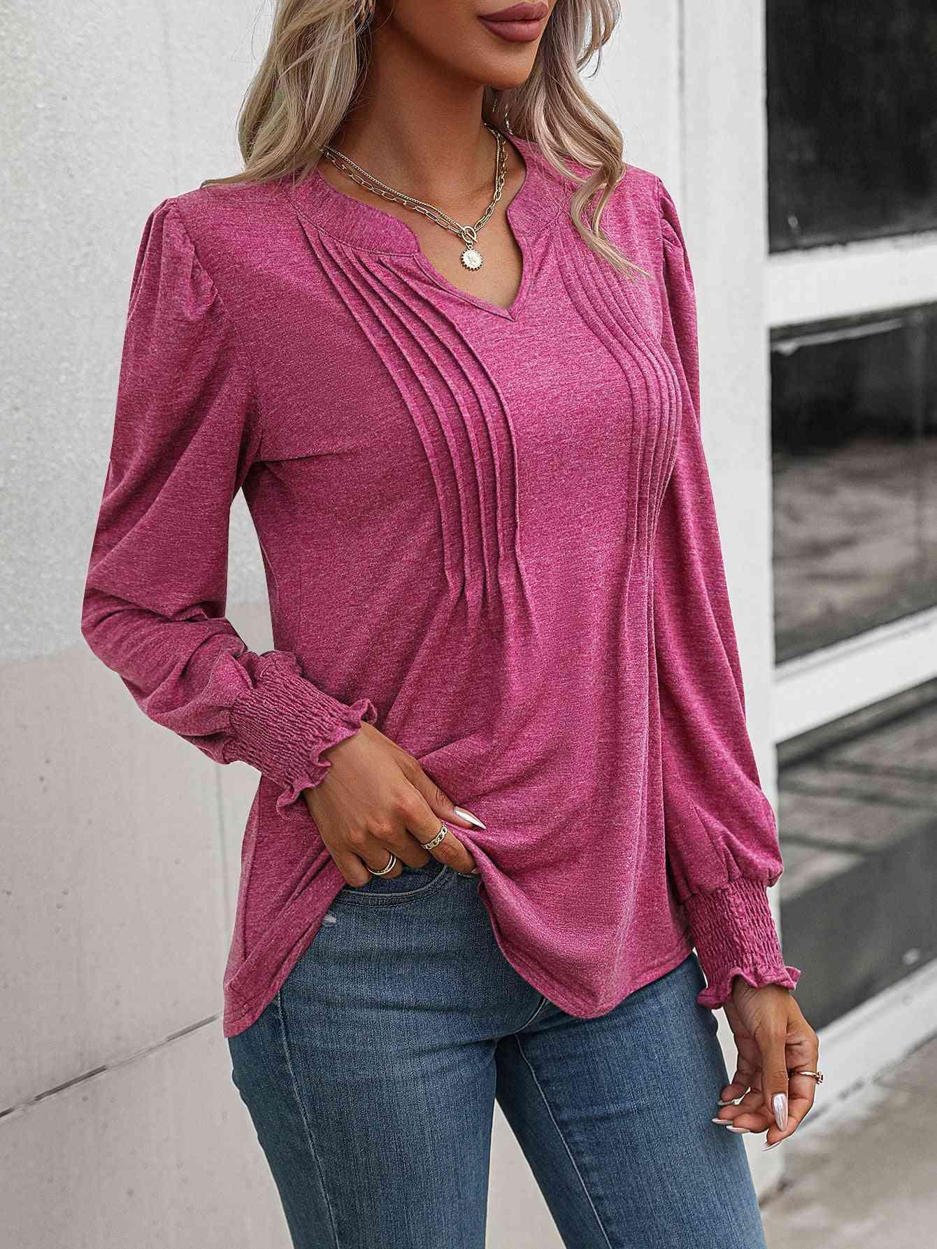 a woman wearing a pink top and jeans