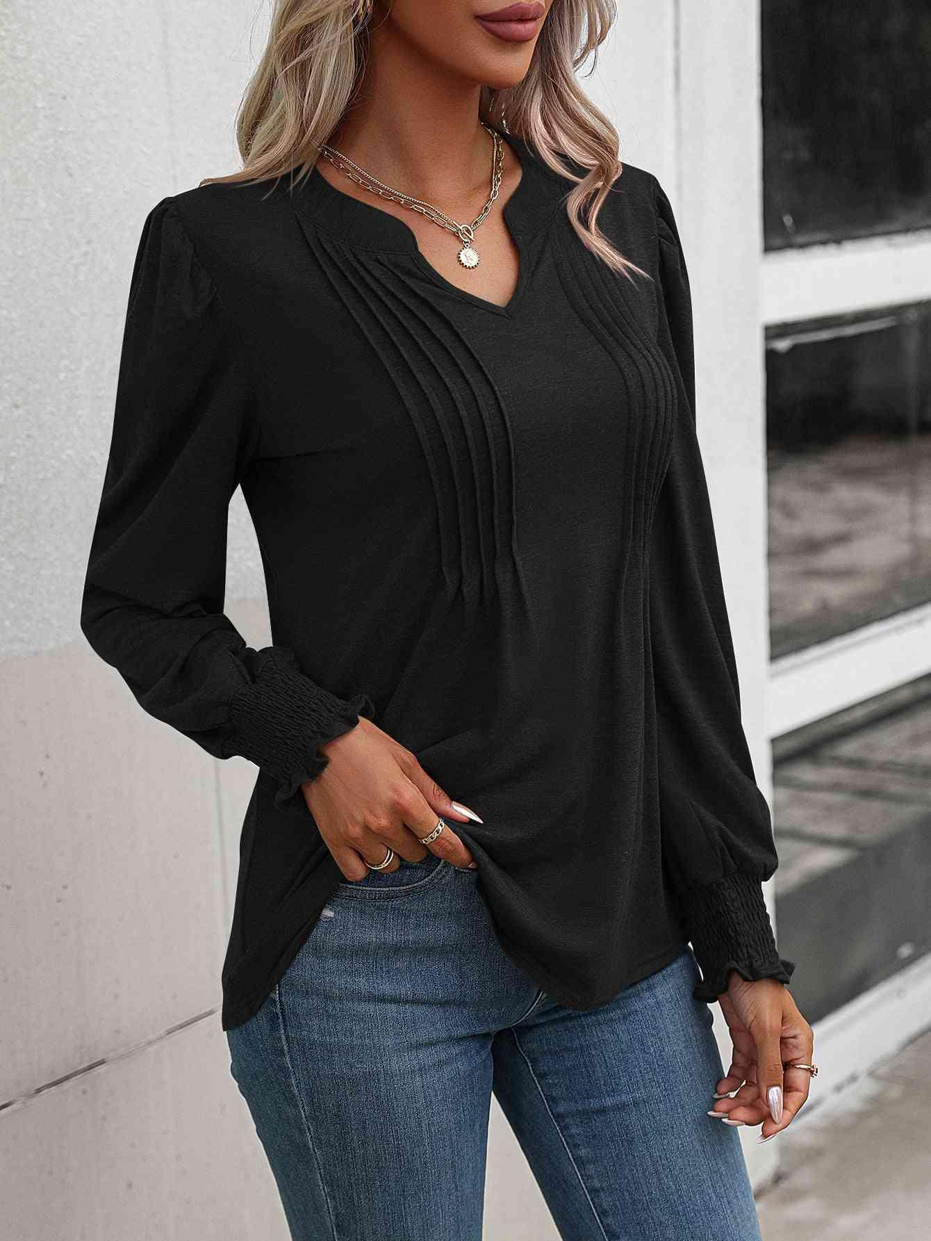 a woman wearing a black top and jeans