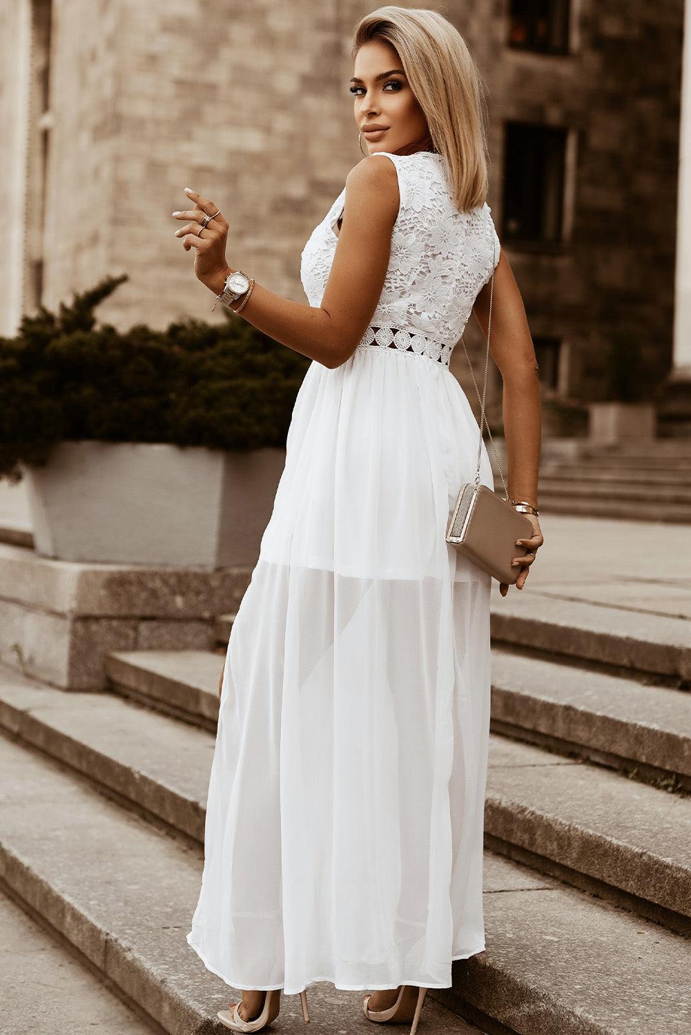 a woman in a white dress standing on some steps