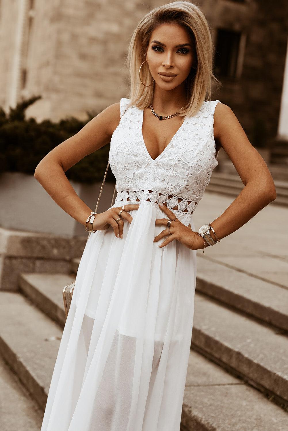 a woman in a white dress standing on some steps