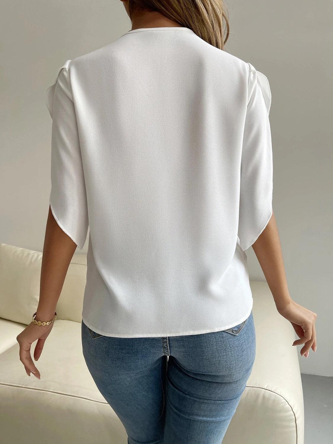 a woman in jeans and a white top