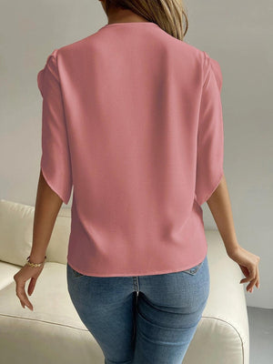 a woman in jeans and a pink top