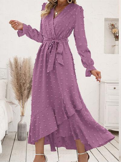 a woman wearing a purple polka dot dress