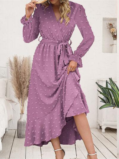 a woman in a purple polka dot dress