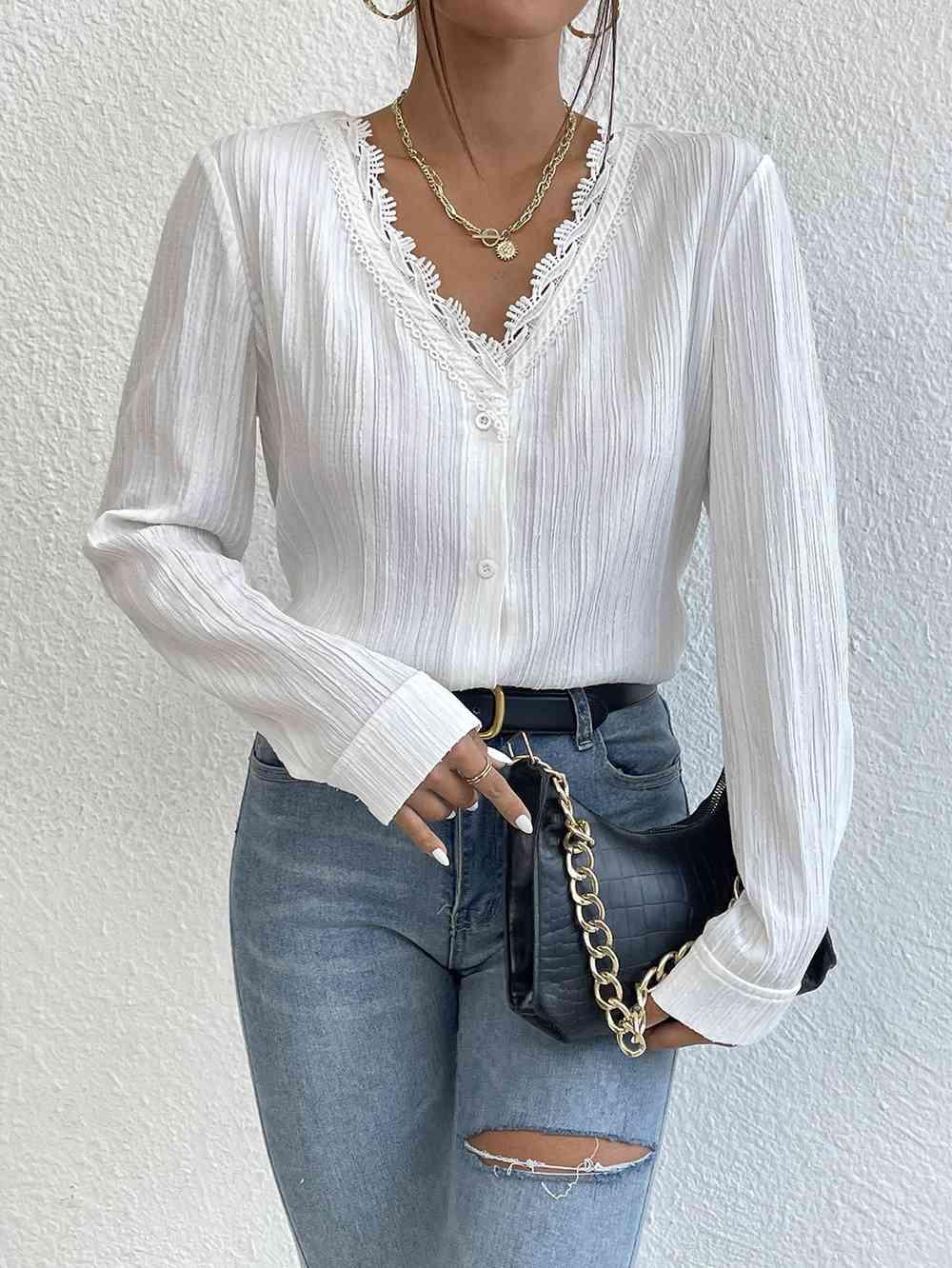 a woman wearing ripped jeans and a white blouse