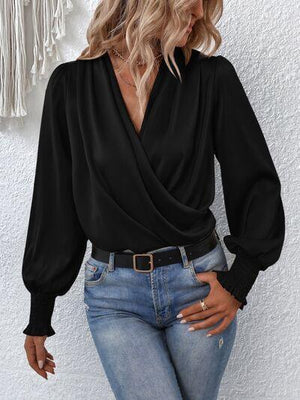 a woman wearing a black blouse and jeans