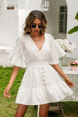 a woman wearing a white dress and sunglasses