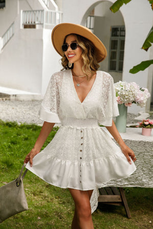 a woman wearing a white dress and hat