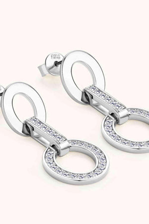 a pair of earrings with diamonds on them