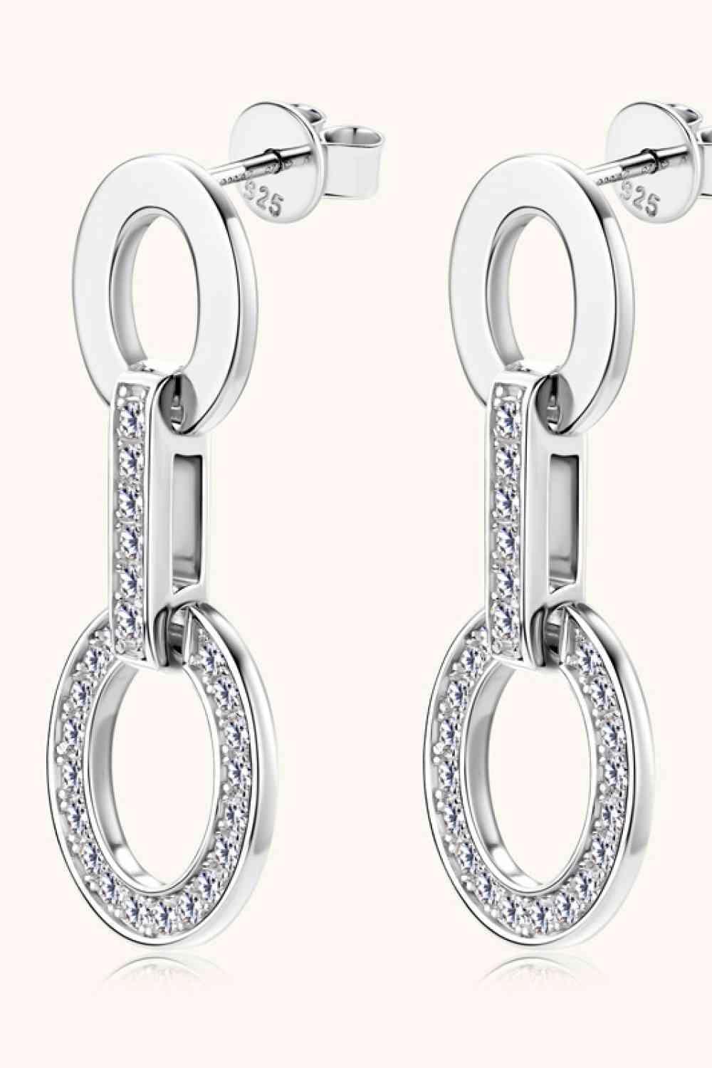 a pair of earrings with diamonds on them